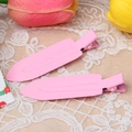 Close-up of pink painted metal alligator hair clips with embossed text on lace fabric - Light Pink
