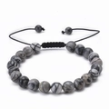 Detail of adjustable woven rope bracelet with grey and black natural stone beads - Grey Map Stone