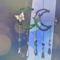 Detailed view of moon and butterfly suncatcher with green crystals and crystal prisms - Green Aventurine