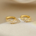 Detailed close-up of V-shaped gold earrings with white zircon on silk background - Gold V-shape Zirconia Earring