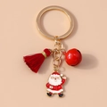 Close-up of Christmas keychain with Santa Claus charm, red bell and tassel detail - Red Santa Claus