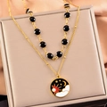 Collana doppia dorata con perline nere e ciondolo sole e luna su tessuto di seta - Stile Luna e Sole