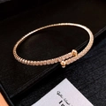 Elegant gold-plated open bangle with micro-paved zircons and polished bead ends - Style 24 / Gold