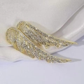 Elegant gold angel wing brooch with sparkling rhinestones on white silk background - Gold Wings Flying Together