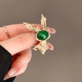 Golden bunny brooch with a large green oval gem and small clear zircon accents - 239# Rabbit