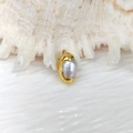 Macro detail of natural grey pearl encased in a gold plated metal frame for DIY jewelry - Rounded Grey Pearl Gold Plated