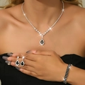 Detailed view of the jewelry set with black teardrop pendants and silver zircon accents - Three-Piece Set / Silver Black