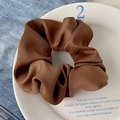 Brown satin oversized scrunchie with silky luster on a decorative ceramic plate - High Satin Chestnut