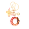 Resin initial keychain with pink butterfly and red gold leaf glitter in round ring - Letter O