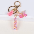 Glitter resin initial keychain with pink tassel and gradient butterfly pendant accessory - Letter I