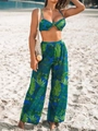 Detailed view of women's bikini top and tropical palm leaf print high-waisted wide-leg pants - Green