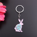 Detail of pink acrylic bunny keychain with floral patterns and pink decorative flower - Red Berry Pink Rabbit