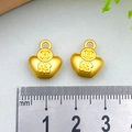 Pair of golden sycee ingot charms with 'Fortune' character, shown with measuring scale - Wealth Ingot (14x12mm)