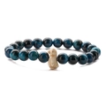Macro shot of blue tiger eye beads with an ivory-white abstract penguin charm bracelet - Peacock Blue Tiger Eye