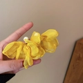 Yellow chiffon butterfly earring with pearl accent held in hand for scale and detail - Yellow Chiffon Pearl Butterfly Drop Earrings