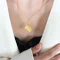 Gold plated double layer necklace featuring heart and moon celestial pendants on female model - Gold