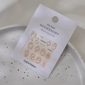 Golden nail art sticker set MJ-055 with pearls and rhinestones on white display tray - Model MJ-055 Gold Foil