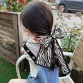 Kids hair accessory featuring a large black and white zebra print bow hair tie - Zebra Print
