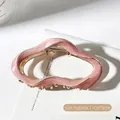 Pink wavy irregular metal claw clip with gold finish measuring 11cm by 6cm - Pink