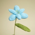 Handmade crochet blue tulip with green leaves and yellow stamens in soft yarn texture - Blue