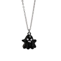 Detailed close-up of a black enamel ghost pendant on a polished silver metal chain necklace - Black (1954)
