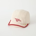 Close-up of baby cotton cap with red piping and tomorrow is another day embroidery - Tomorrow / Off White