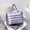 Quilted shiny purple tote bag with adjustable shoulder strap on a white chair - Purple