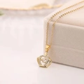 Macro shot of gold crown pendant with a dancing zircon stone on a jewelry box edge - Crown Necklace