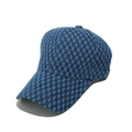 Close-up of textured blue denim baseball cap with distressed details and 6-panel design - Blue