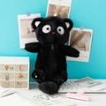 Gros plan d'une trousse chat noire en peluche avec de grands yeux et un nez rouge - Chat Noir