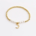 Bracciale di perle dorate con ciondolo a luna in zircone scintillante su sfondo bianco - Ciondolo Luna Dorata-CCB0361