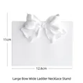 White plaster necklace display stand with large bow detail, sized 11cm by 12.6cm - Large Bowknot Wide Ladder Necklace Stand
