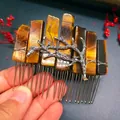 Macro detail of handmade tiger eye stone hair comb with silver branch accents - Tiger Eye + Branch