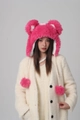 Detail of bright pink plush trapper hat featuring cute bear ears and fuzzy pompom ties - Rose Red