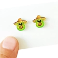 Close-up of mini avocado stud earrings with sombrero hats and green glitter finish - Avocado with Sombrero