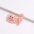 Close-up of a cute pink acrylic cartoon cat brooch pin with a smooth polished finish - 6.5cmx5.0cm / Pink