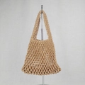 Close-up of khaki woven cotton rope net bag showing detailed handmade knots and mesh texture - Tan