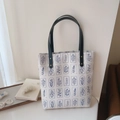 Detail of white canvas tote bag with blue floral patterns and sturdy dark leather straps - Vertical Magnetic Shoulder Bag (Large)
