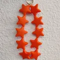 Cute keychain featuring ten orange silicone star beads with a silver metal ring loop - Orange (10 Stars)
