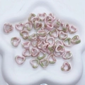 Pink and green ink-wash heart beads displayed on a white cloud-shaped tray - Pink & Green Gradient