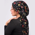Floral print headscarf in black with red and yellow patterns shown on a side-view model - Black with Leaves