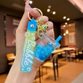 Luminous blue bubble tea cup keychain with flowing liquid and star sequins on wrist strap - Blue Luminous Bubble Bead Milk Tea Cup