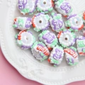 Macro shot of colorful DIY resin beads with Lucky and Happy text for handmade crafts - White Happy Purple Heart Luck