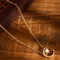 Close-up of golden star and moon pendant necklace with micro diamonds on wood - Star and Moon Necklace (Gold)