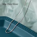 Silver stainless steel box chain necklace with smooth square links shown on green fabric - 45 cm / Box Chain (Silver Tone)