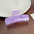 Holographic purple acetate hair claw clip with marble texture on dark wood surface - Iridescent Purple Barrette