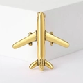 Detailed view of a vintage golden airplane brooch pin on a clean minimalist background - Antique Gold