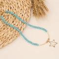 Bohemian turquoise beaded necklace featuring a colorful crystal star pendant on beige background - Pentagram Pendant Turquoise Beaded Style (N1027)