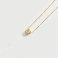 Collier à pendentif cube doré avec motif lettre R étincelant sur fond blanc épuré - Lettre R (XL3420)