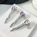 Minimalist liquid metal bow hair clips with heart crystals on stone background - Silver Liquid White Heart Crystal
